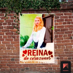 Poster of a woman hanging on a brick wall